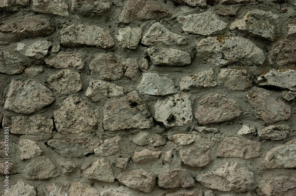 abstract grunge background: rough wall of granite stones and concrete