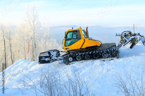 tractor for leveling snow at ski resorts. preparation of a ski track in a forest area