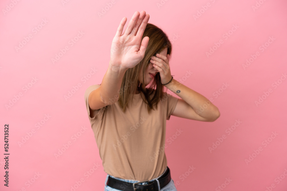 Young English woman isolated on pink background making stop gesture and covering face Young English woman isolated on pink background making stop gesture and covering face