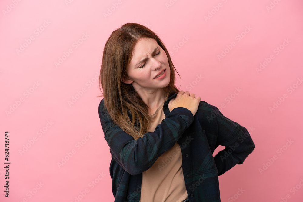 Young English woman isolated on pink background suffering from pain in shoulder for having made an effort Young English woman isolated on pink background suffering from pain in shoulder for having made an effort