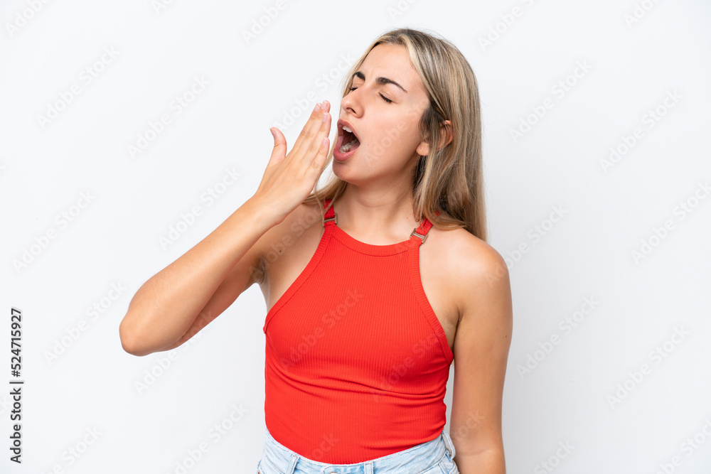Young caucasian woman isolated on white background yawning and covering wide open mouth with hand Young caucasian woman isolated on white background yawning and covering wide open mouth with hand