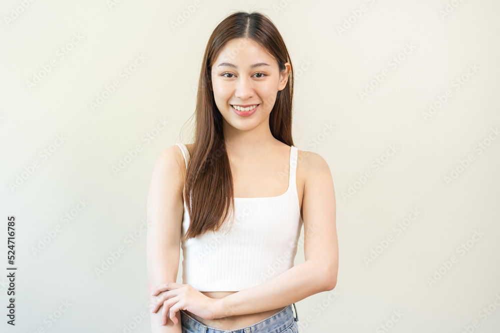 Smiling positive, attractive asian young woman wearing casual dress, portrait of beautiful brunette her with long brown hair, feeling happy looking to camera standing isolated on white background. Smiling positive, attractive asian young woman wearing casual dress, portrait of beautiful brunette her with long brown hair, feeling happy looking to camera standing isolated on white background.