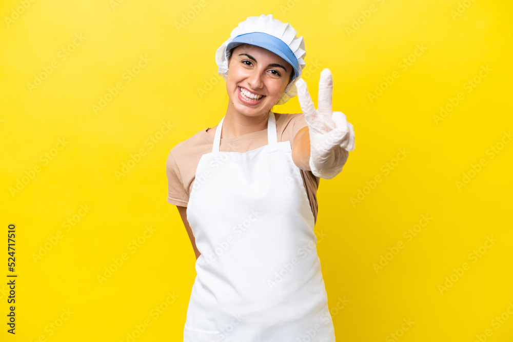 Fishwife woman over isolated background smiling and showing victory sign Fishwife woman over isolated background smiling and showing victory sign