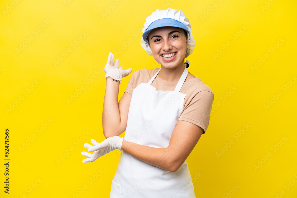 Fishwife woman over isolated background extending hands to the side for inviting to come Fishwife woman over isolated background extending hands to the side for inviting to come