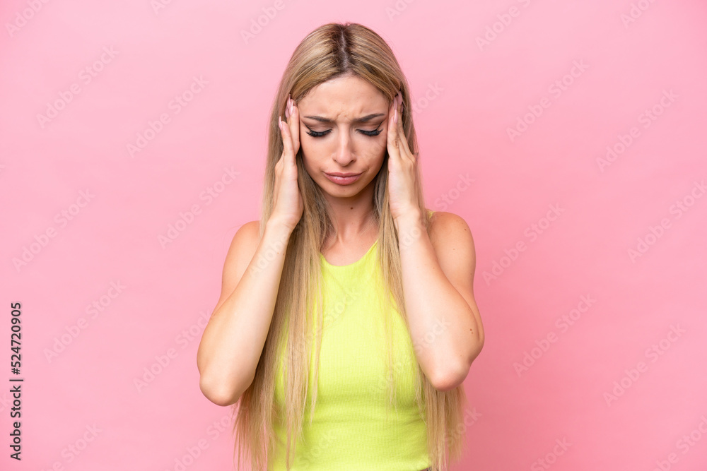 Pretty blonde woman isolated on pink background with headache Pretty blonde woman isolated on pink background with headache