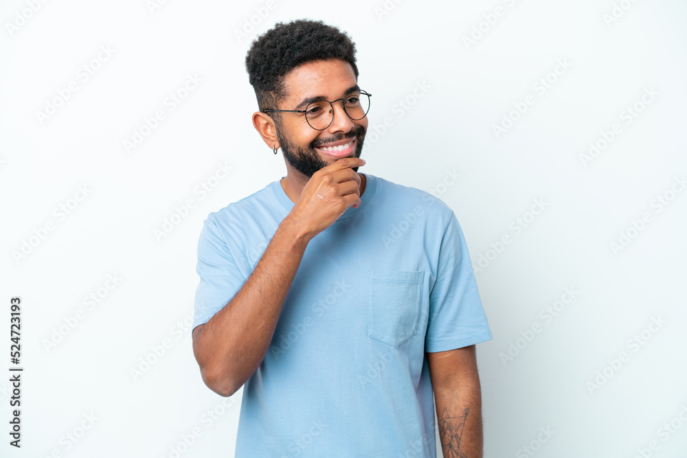 Young Brazilian man isolated on white background looking to the side and smiling Young Brazilian man isolated on white background looking to the side and smiling
