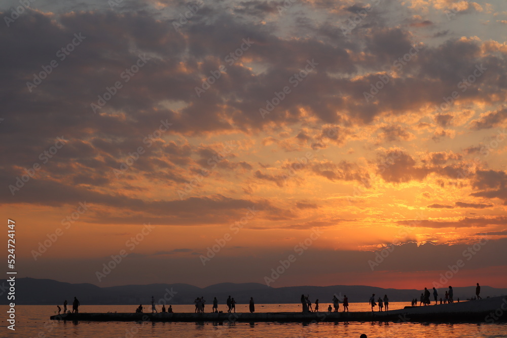 Sunset on the sea. Beautiful sky with fragments in the rays of the sun.