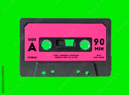 An old vintage cassette tape, isolated on a green background, with some text on the label (Side A, 90 Min) and an empty space for the title.
