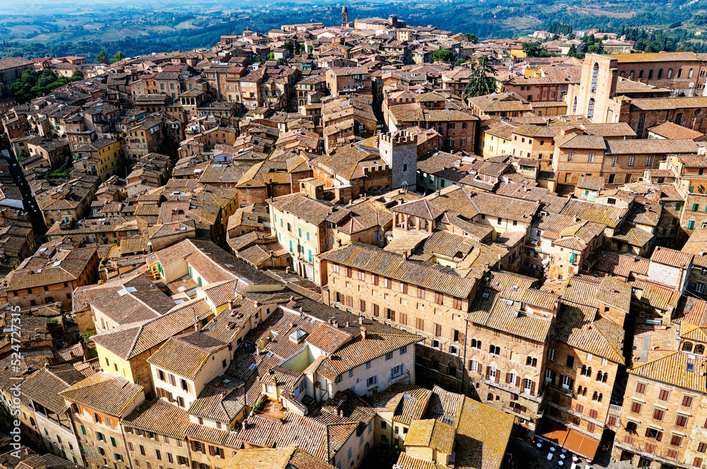 Sienna, Tuscany, Italy. View across the mediaeval city rooftops terracotta tiles from the top of the Torre del Mangia