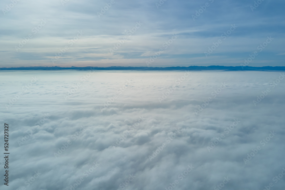 Aerial view from high altitude of earth covered with puffy rainy clouds forming before rainstorm