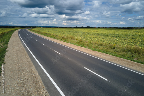 Schilderij op canvas Aerial view of empty intercity road between green agricultural fields
