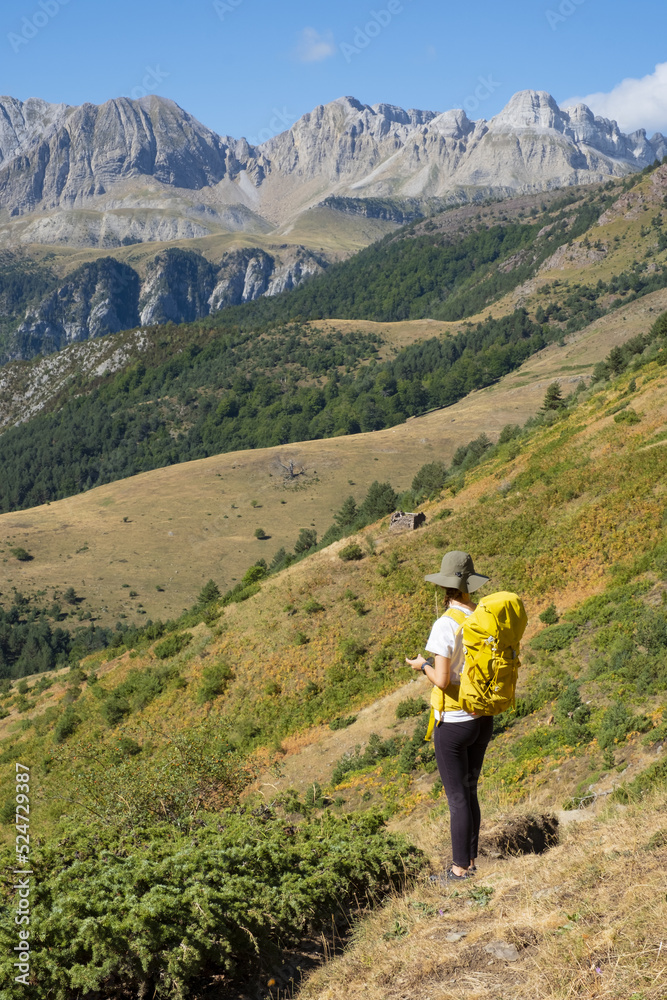 Woman walking in the Natural Park of the Western Valleys , Huesca Pyrenees