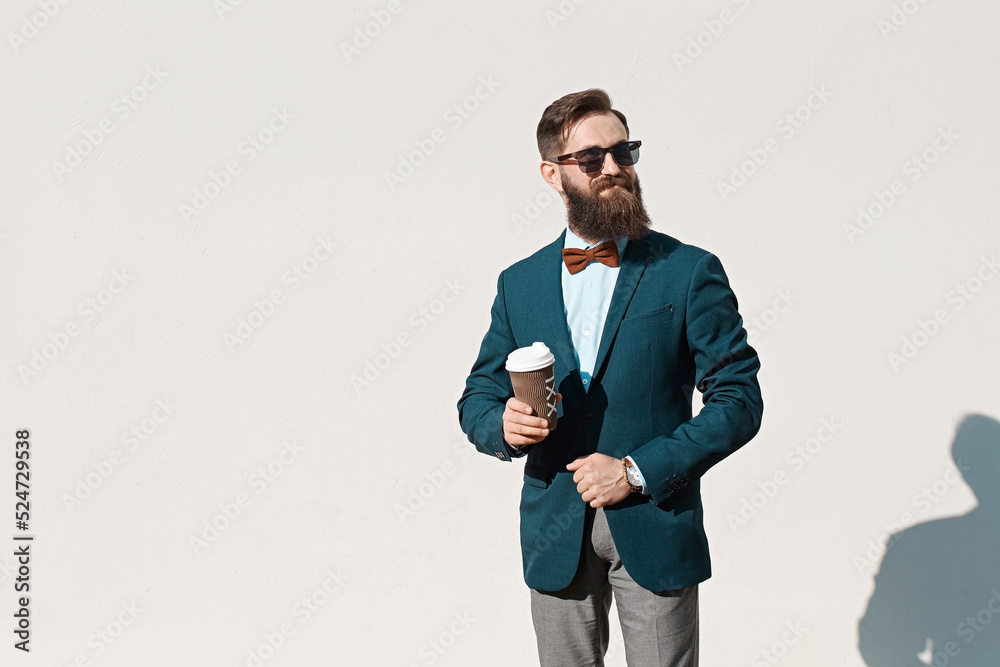 Stylish man with beard wearing a jacket, shirt and bow tie