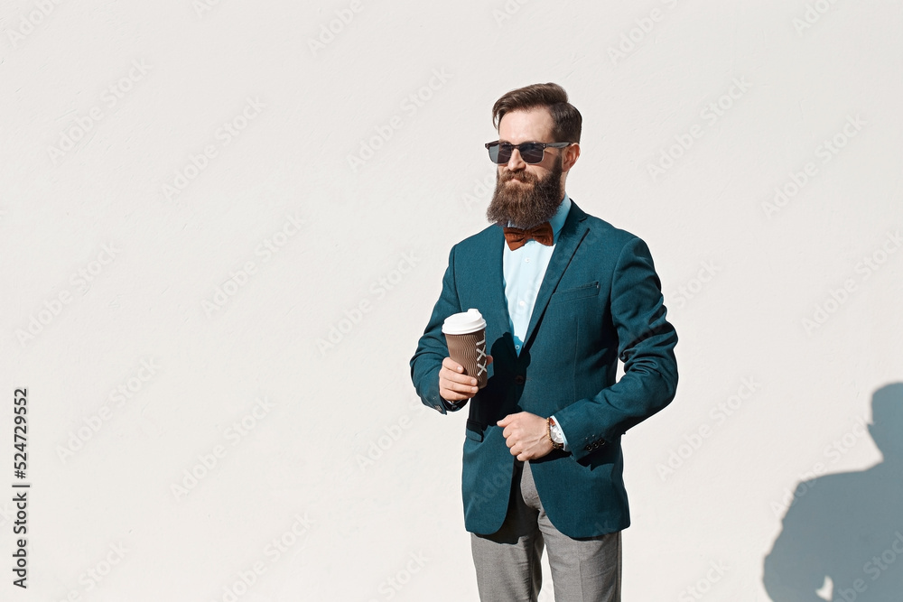 Stylish man with beard wearing a jacket, shirt and bow tie