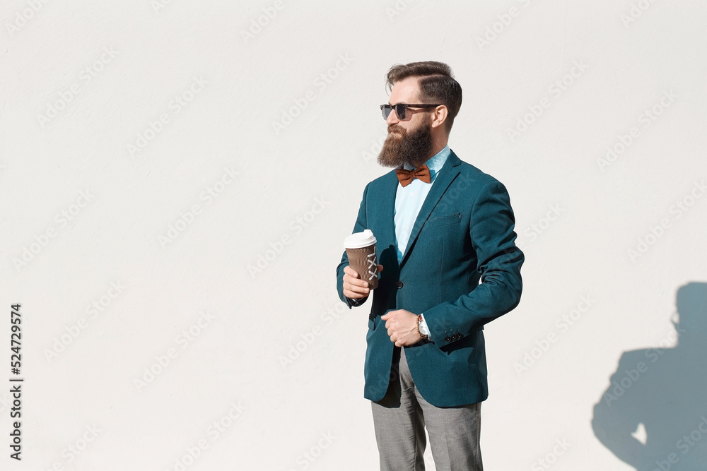 Stylish man with beard wearing a jacket, shirt and bow tie