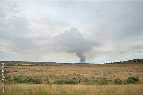 Wildfire smoke pillar blocking out the sun on a cloudy stormy blustery dark day in the late afternoon or early evening