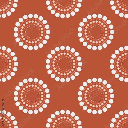 Circle dots repeat pattern sienna background with beige, peach coral and rust colors.
