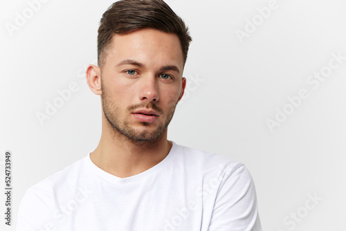 Sad frustrated unhappy tanned handsome man in basic t-shirt tired of problems look at camera posing isolated on white studio background. Copy space Banner Mockup. People emotions Lifestyle concept