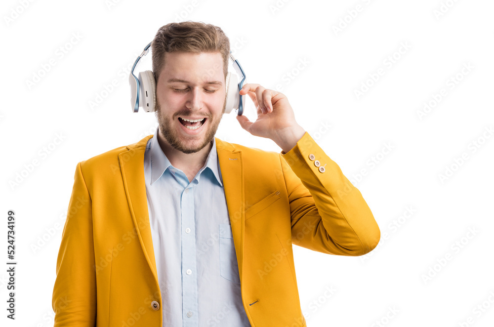 Good looking optimistic man wearing wireless headphones with closed eyes and singing along to audio track. Young male gladfully enjoying good music in studio.