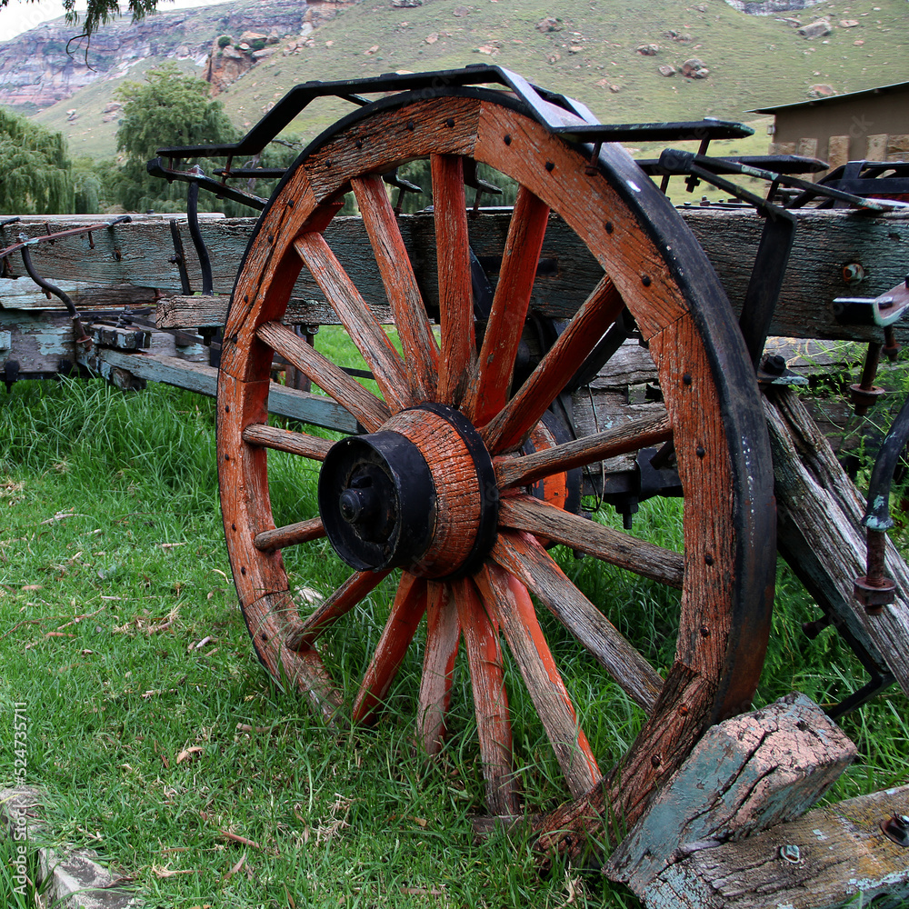 Closeup of a red wooden wheel and spokes. Old ox wooden wagon from early 1900s. Clarens, Free State, South Africa