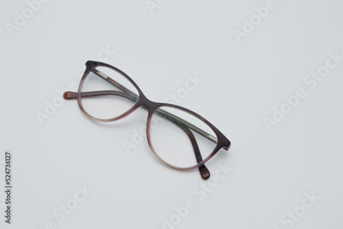 Glasses are transparent for reading or good vision, lie folded. on a light background. View from above