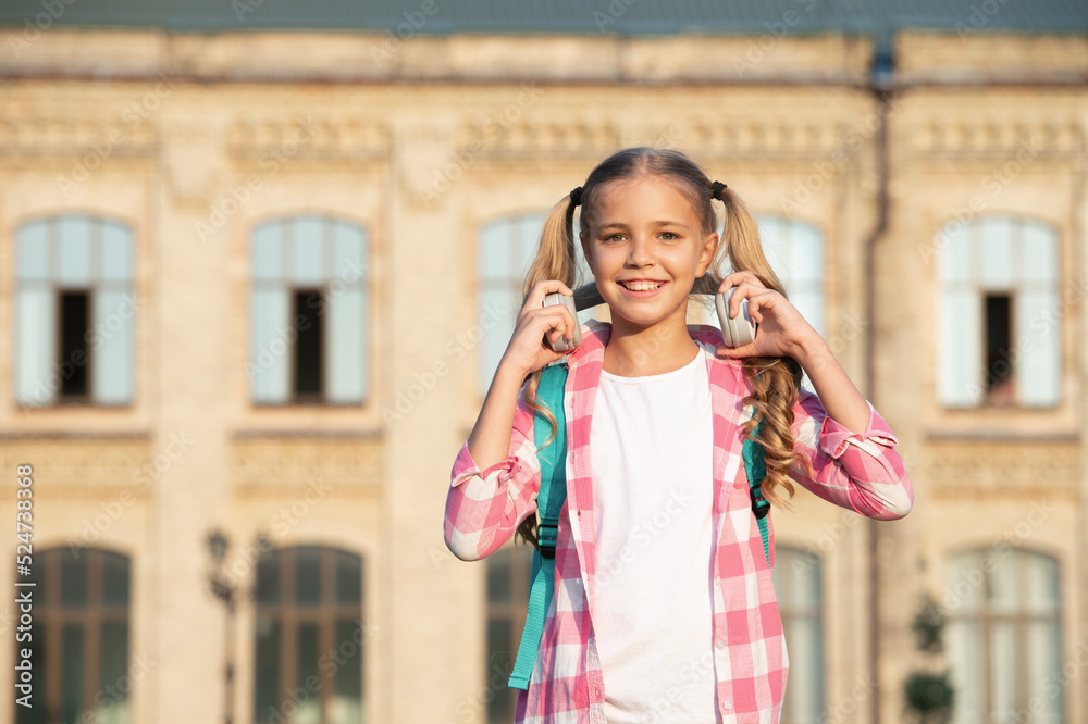 Happy teen girl back to school outdoors, copy space Happy teen girl back to school outdoors, copy space
