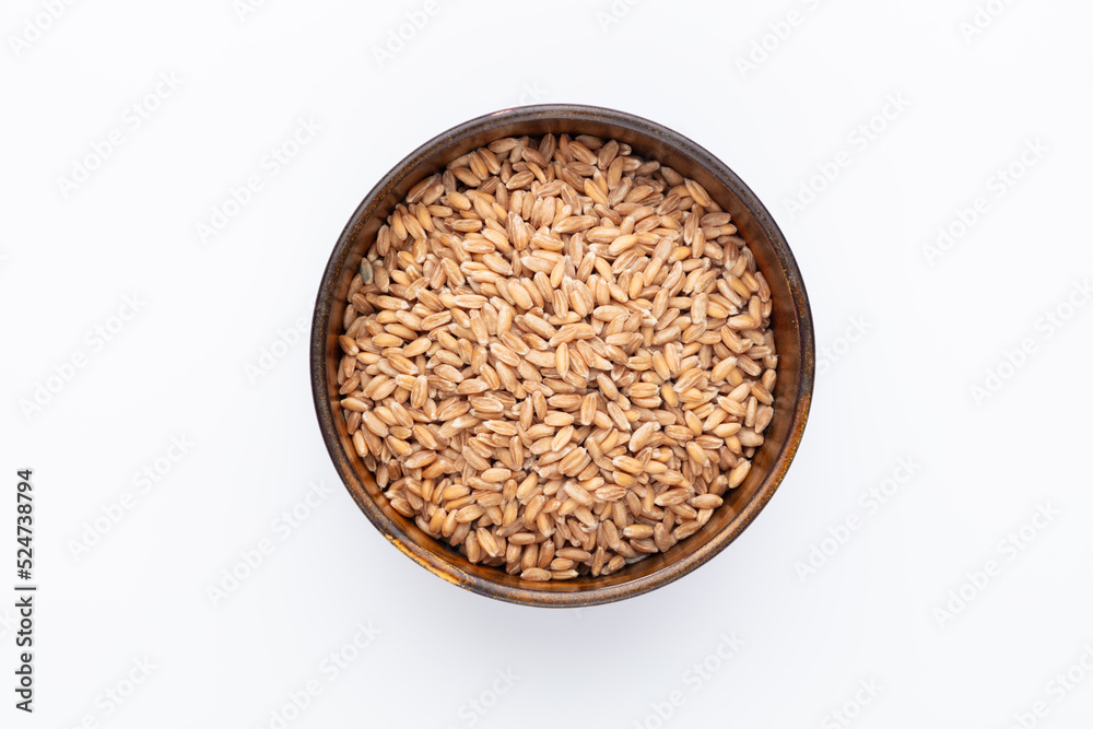 Wheat grains and wooden bowl on white background. Wheat grains and wooden bowl on white background.
