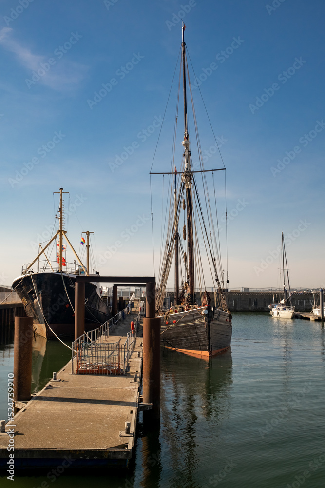 Front on view of a traditional smack moored in Lowestoft docks on the Suffolk coast. Captured on a bright and sunny day Front on view of a traditional smack moored in Lowestoft docks on the Suffolk coast. Captured on a bright and sunny day