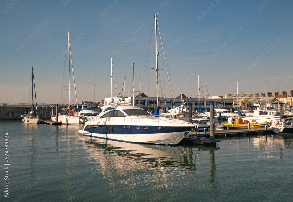 Boats and leisure craft moored up in Lowestoft marina and docks on the Suffolk coast. Captured on a bright and sunny morning