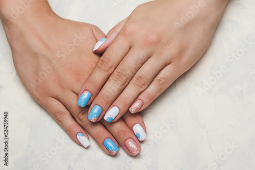 Geometry nail art design in white and blue colors on light background