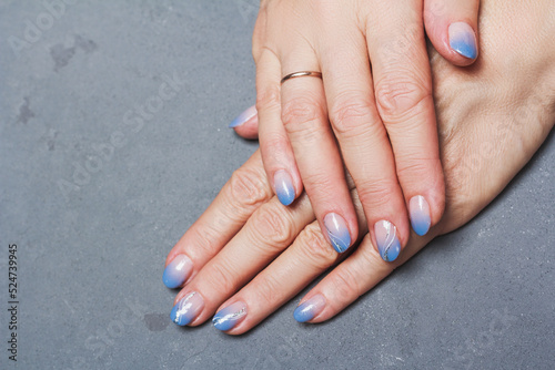 Blue winter nail art design on grey background
