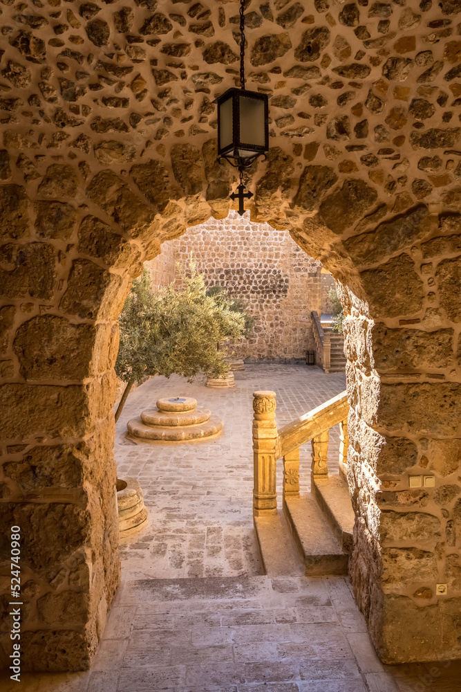 Fototapeta premium Arched way to inner yard of the Mor Hananyo Monastery in Mardin, Turkey