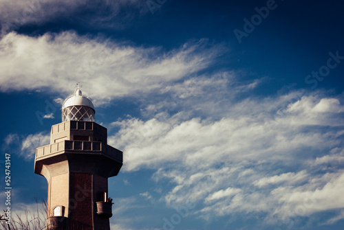 Lighthouse. Structure by the sea. Marine sign.