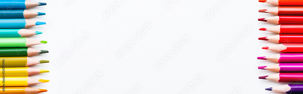 Rows of colored pencils on white background. School supplies with copy space on white background. Top view on kid's stationery. Back to school backdrop. Rows of colored pencils on white background. School supplies with copy space on white background. Top view on kid's stationery. Back to school backdrop.