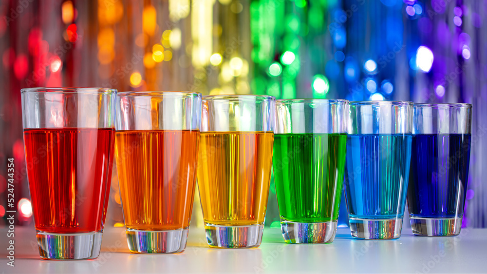 Rainbow drink. Glass of alcohol liquor. Bar counter. Rainbow colors