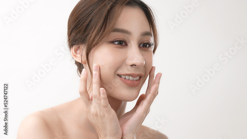 Beauty concept of 4k Resolution. Asian girl is touching her face on a white background.