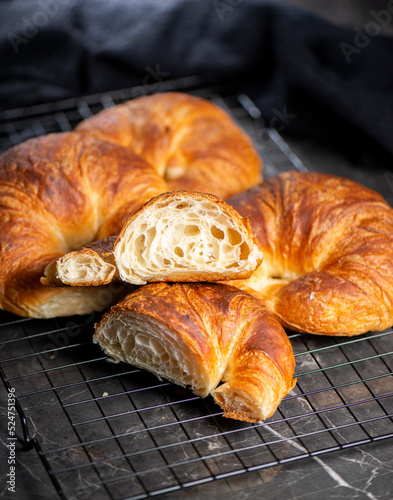 Detailed close-up of delicious buttery traditional croissants with a crescent moon shape.