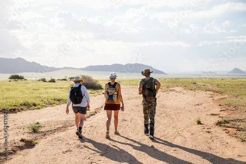 hikers in the namibia desert towards the mountains