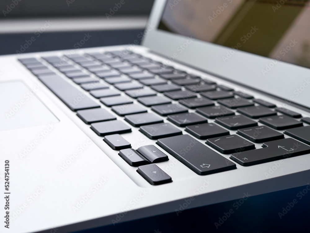 The keyboard of a modern ultra thin laptop, close-up, side view, nobody. Notebook keys shift, enter. Office work, online work. The keyboard of a modern ultra thin laptop, close-up, side view, nobody. Notebook keys shift, enter. Office work, online work.