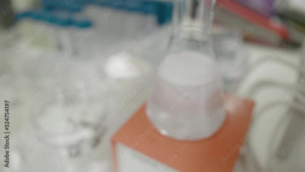Magnetic mixer with fast moving stir bar for mixing liquid at medical factory. Science, pharmaceutical, biotechnology, chemistry laboratory equipment, push back to blur shot Magnetic mixer with fast moving stir bar for mixing liquid at medical factory. Science, pharmaceutical, biotechnology, chemistry laboratory equipment, push back to blur shot