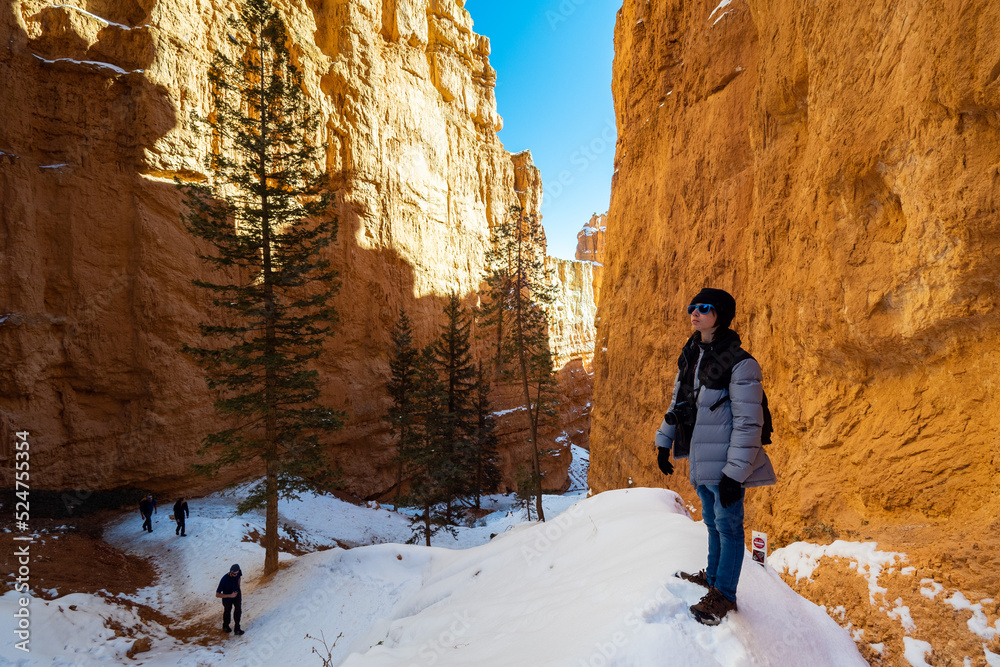 Teen boy hiking in Bryce Canyon in winter snow, Utah USA