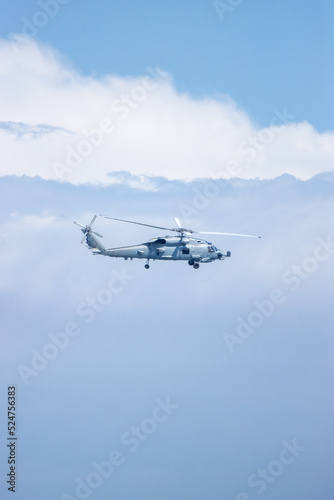 Fototapeta Naklejka Na Ścianę i Meble -  Military Helicopter flying in the air, clouds
