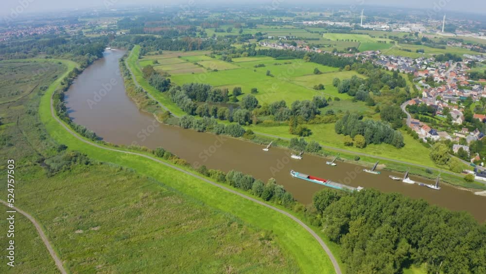 Drone navigating over a landscape with a barge in its view Drone navigating over a landscape with a barge in its view