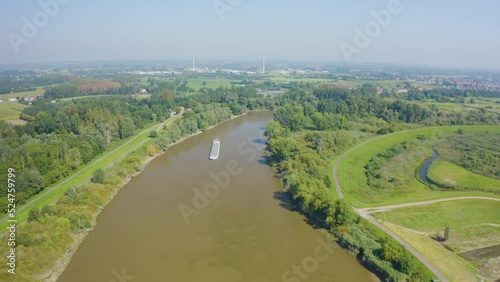 Drone navigating over a landscape with a barge in its view photo