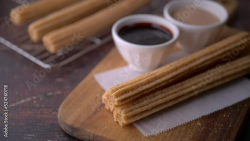 churros with chocolate sauce and cinnamon powder