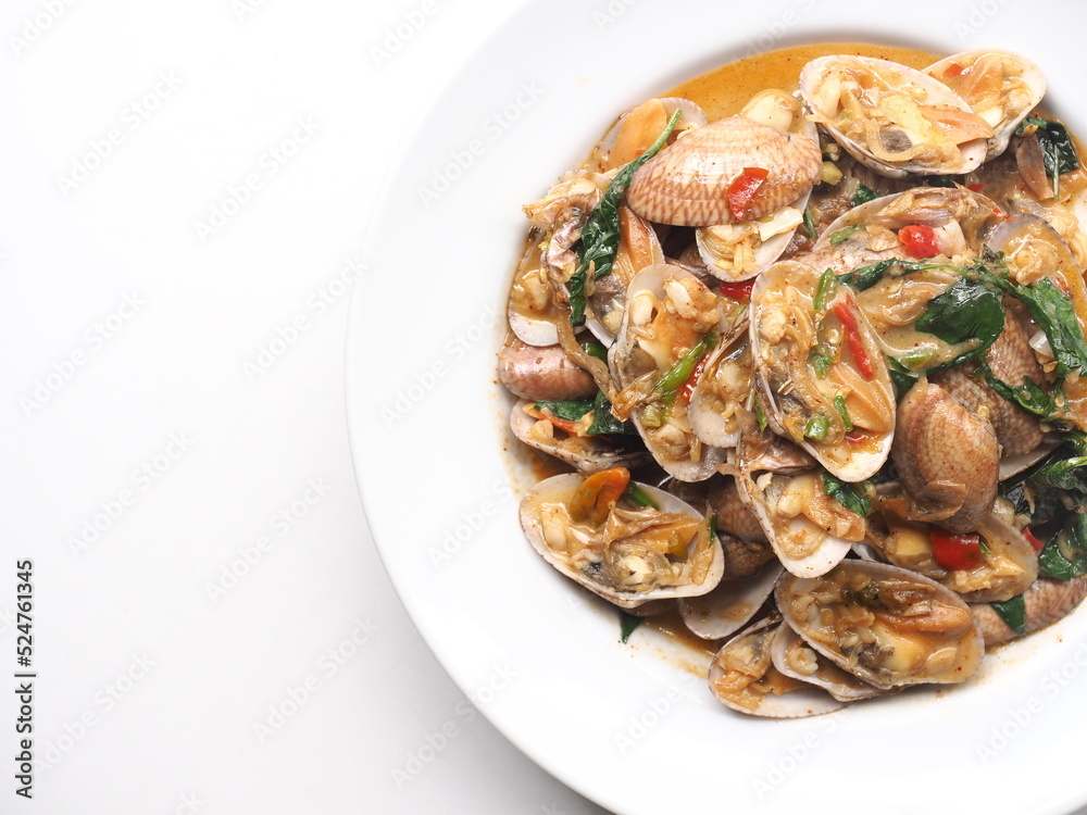 Dish of stir fried Thai clams with roasted chili paste on white background