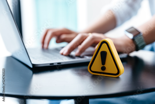 Warning sign placed on a table while businesswoman work, Network security, Dangerous information alert and incorrect data connection password concept Fototapet