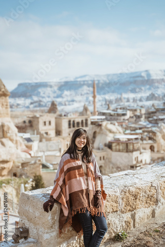 portrait of young happy attractive woman in snowy cappadocia © Odua Images
