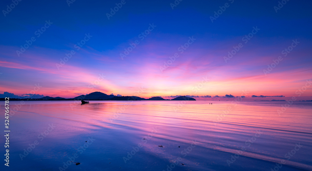 Obraz premium Landscape Long exposure of majestic clouds in the sky sunset or sunrise over sea with reflection in the tropical sea.Beautiful cloudscape scenery.Amazing light of nature Landscape nature background