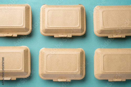 Recycle Eco-friendly disposable food container made of kraft paper on a green background